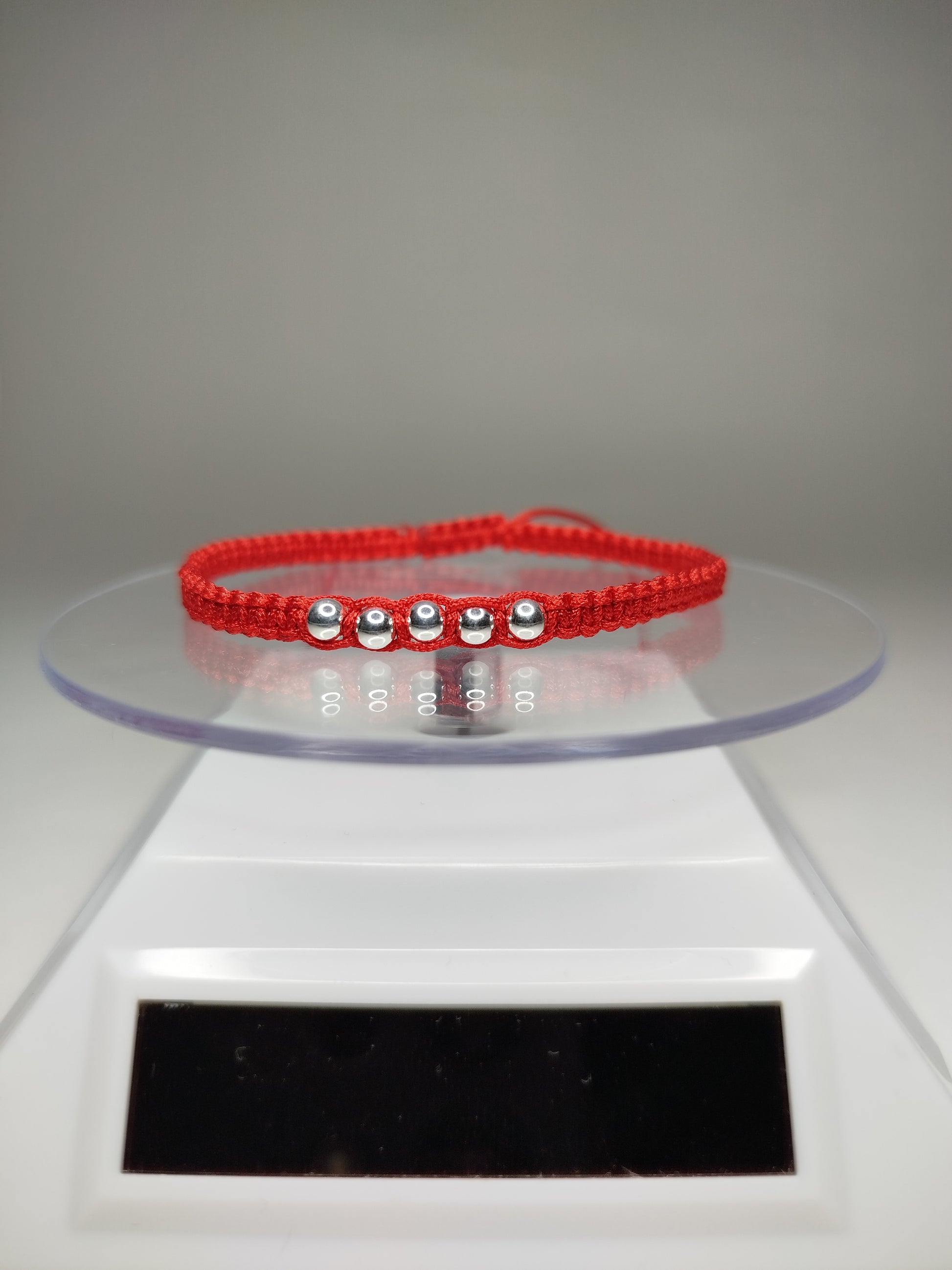 Pulsera de hilo rojo con 7 pelotitas de plata 950