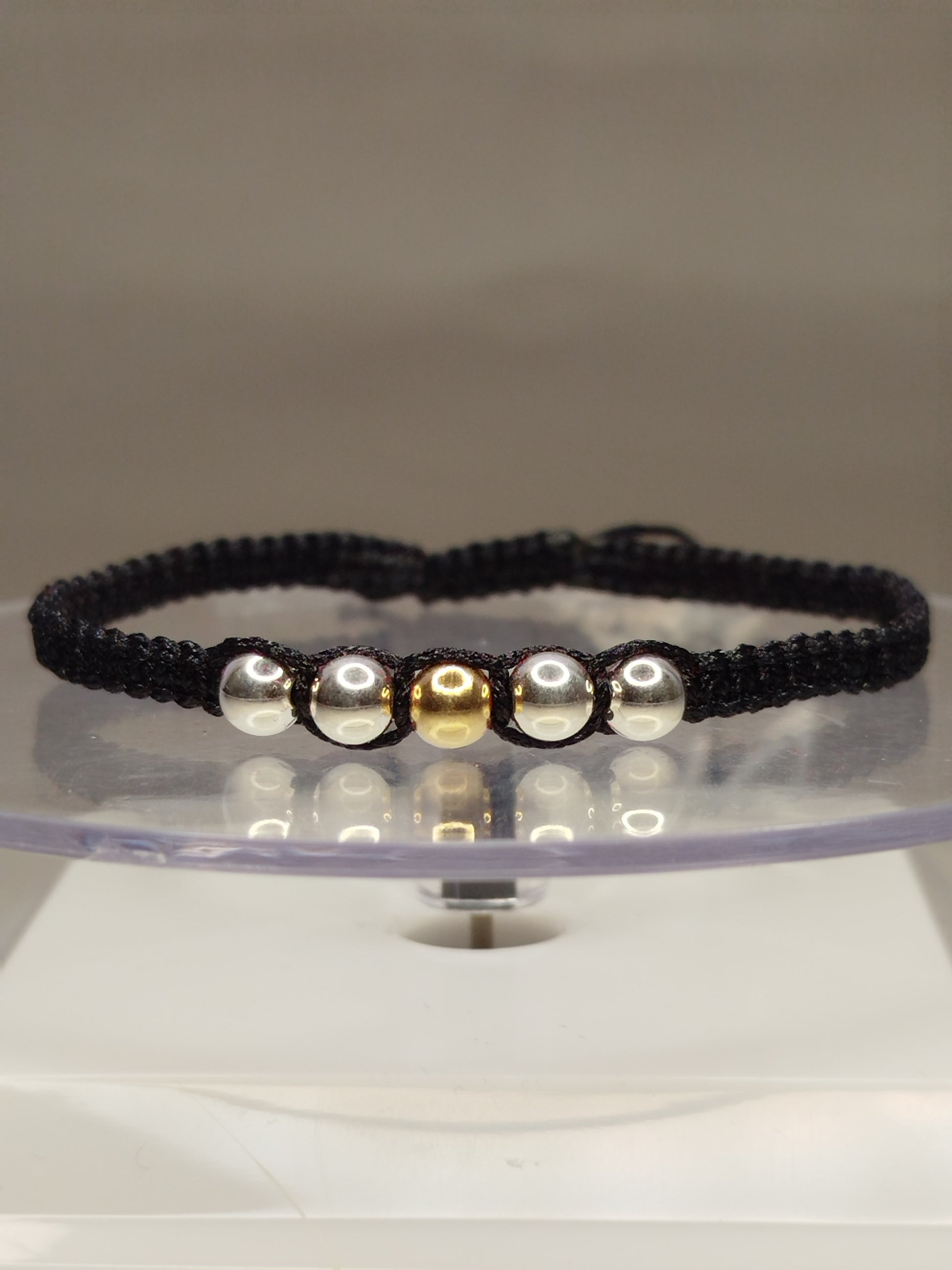 Pulsera de hilo negro con 1 pelotitas de oro 18k y 6 pelotitas de plata 950