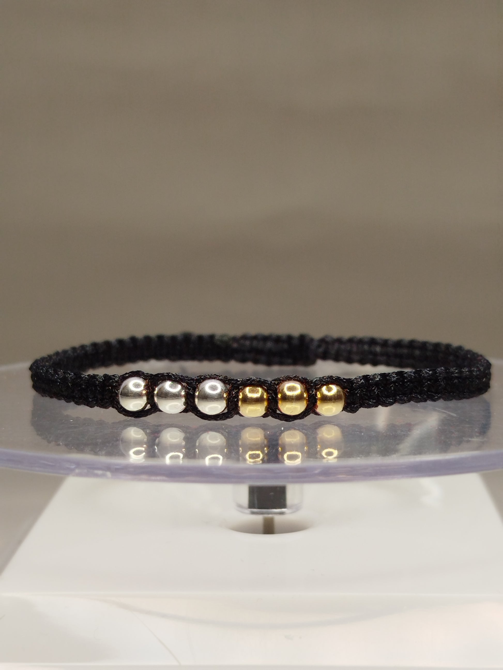 Pulsera de hilo negro con 4 pelotitas de oro 18k y 4 pelotitas de plata 950