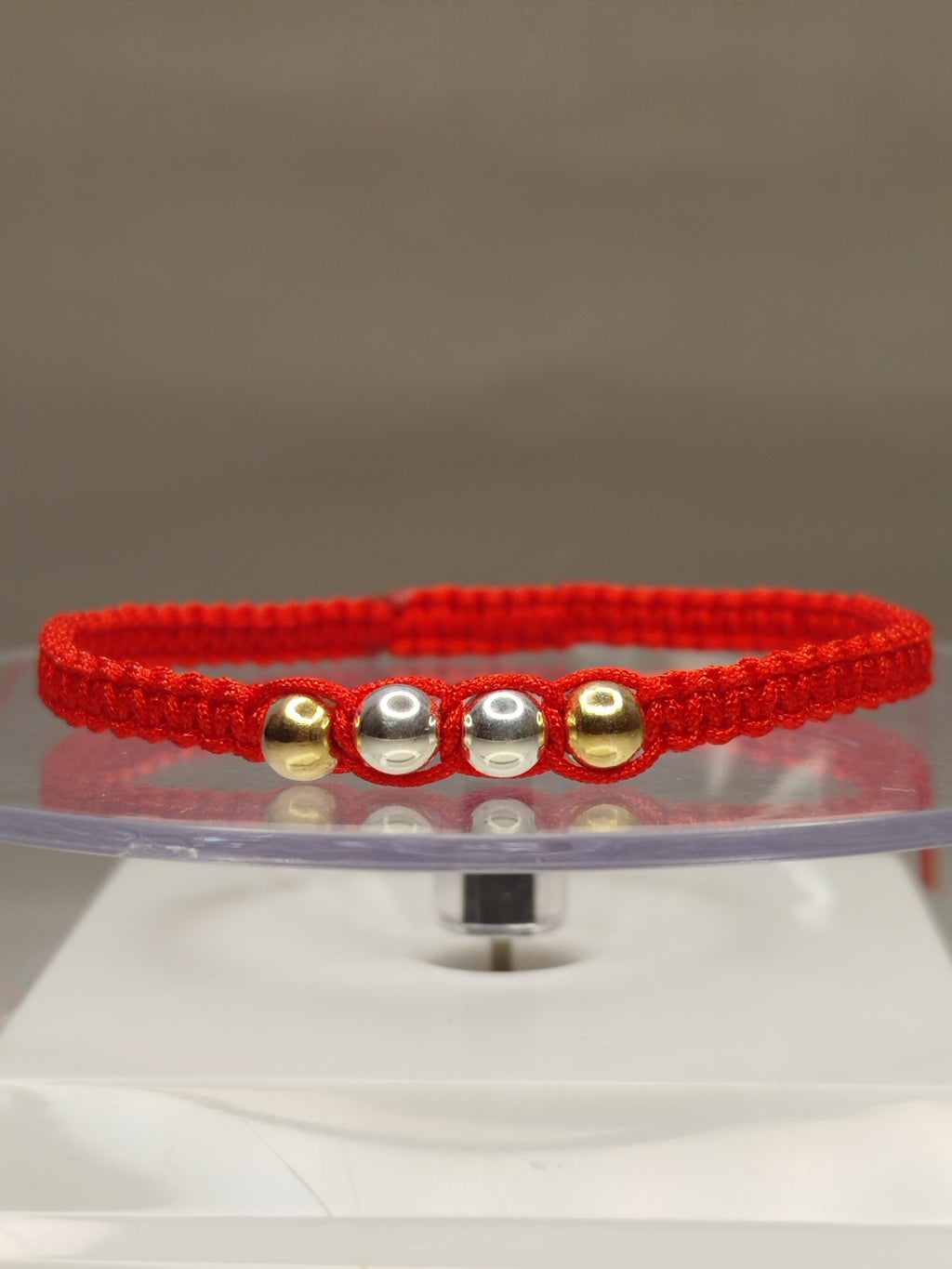Pulsera de hilo rojo con 2 pelotitas de oro 18k y 4 pelotitas de plata 950